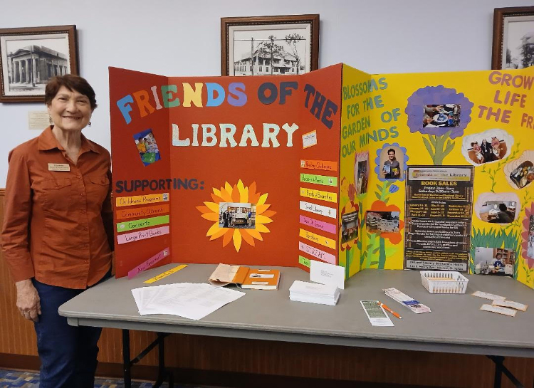 Woman standing in front of posters